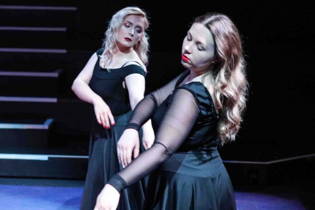 Actors dancing on stage